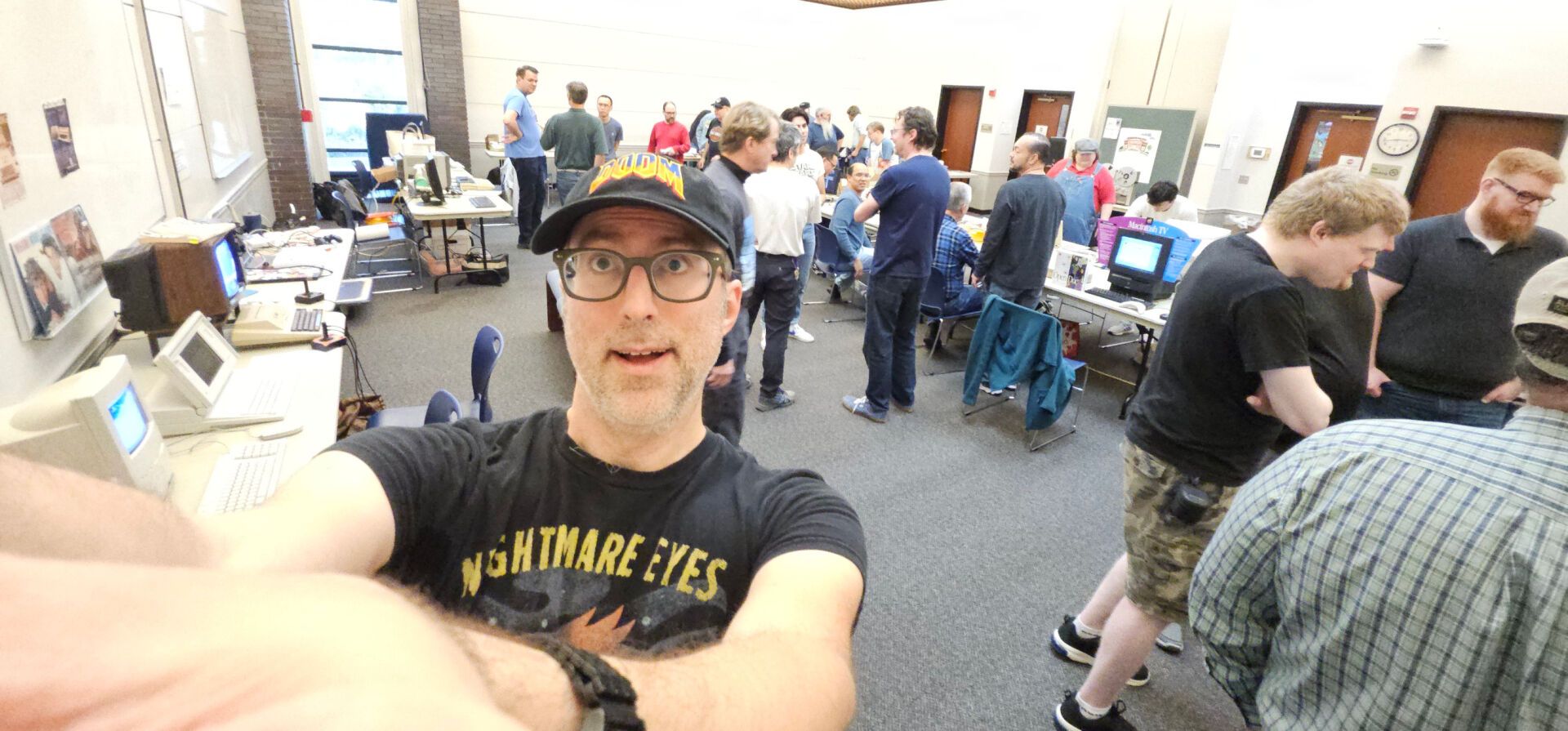 Wide shot of me in a conference room with retro computers and other people.