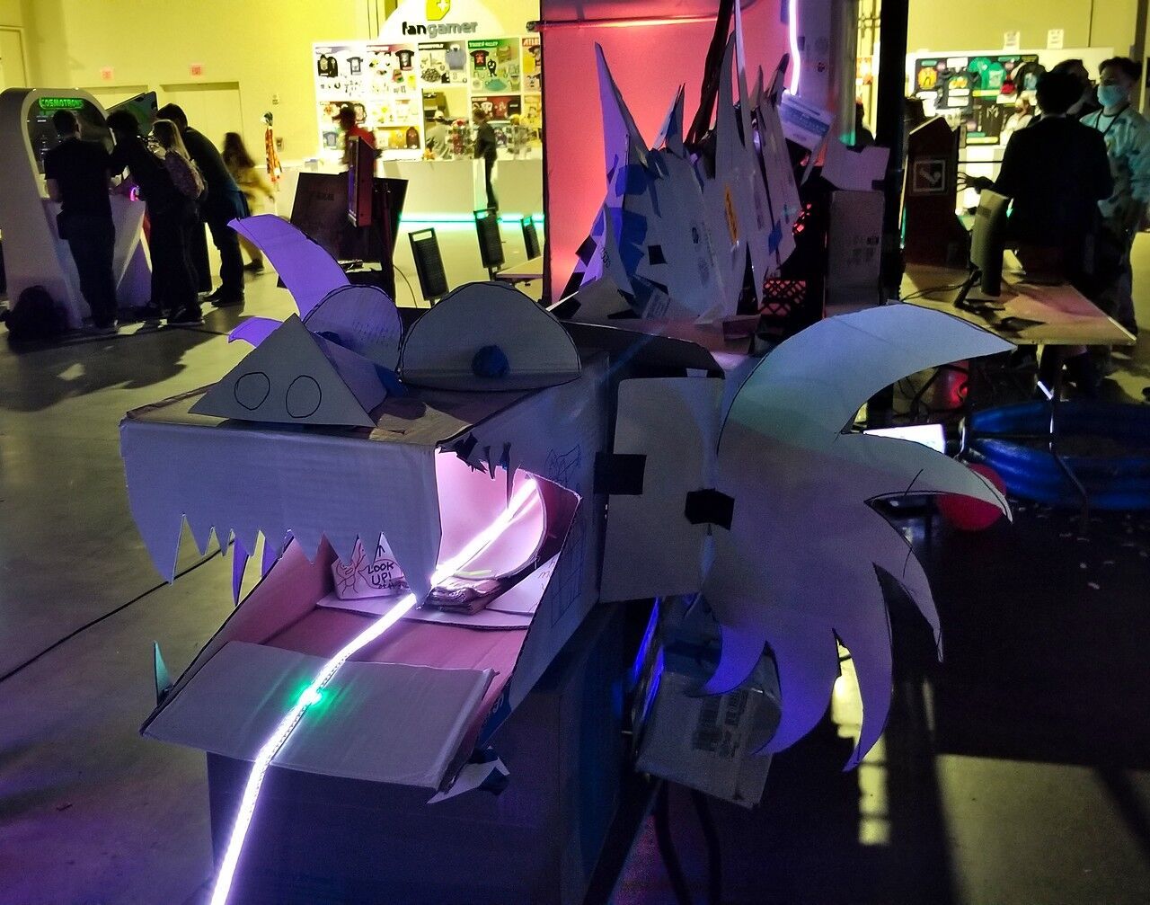 A cardboard dragon with an RGB LED strip running into its mouth.