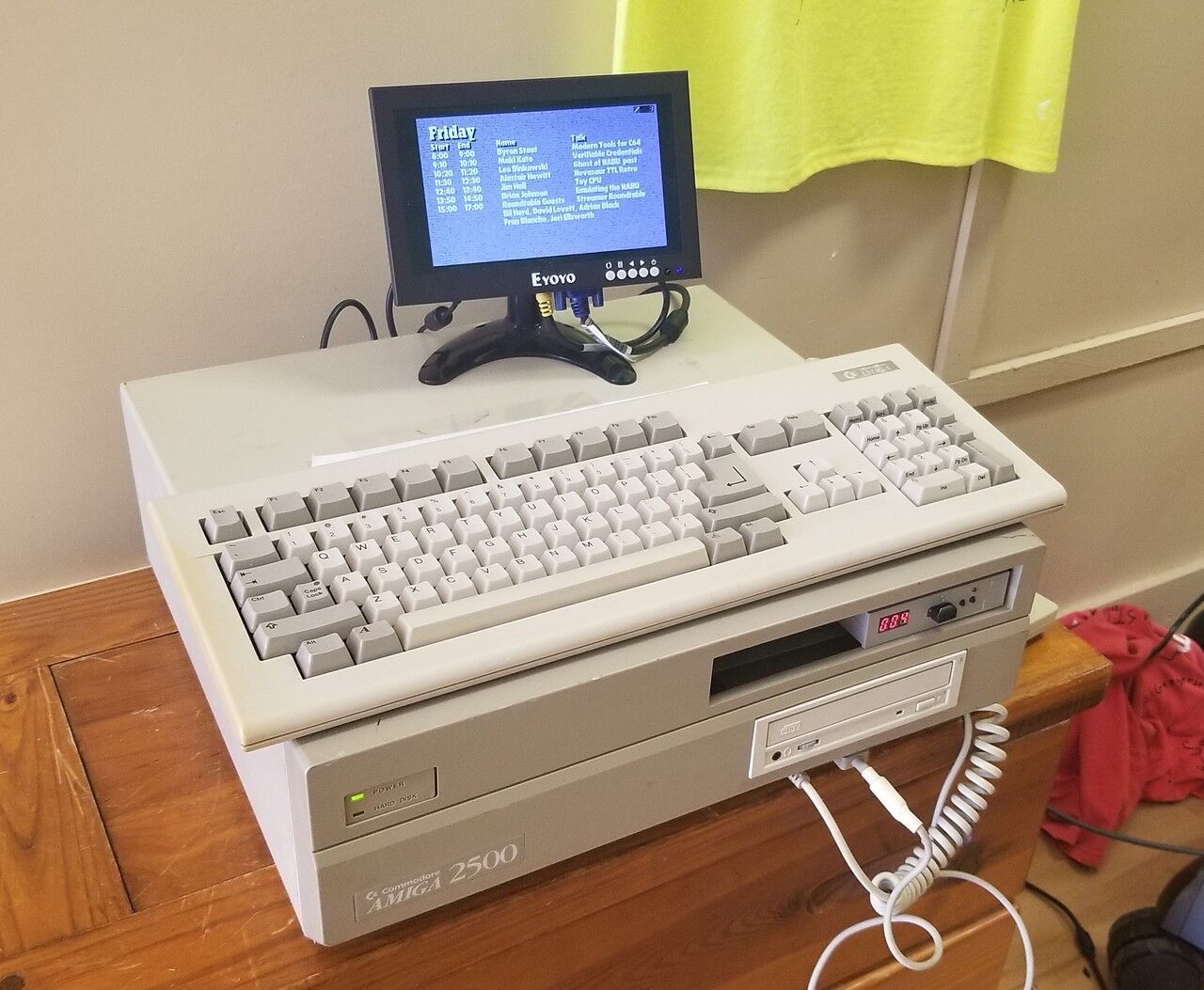 An Amiga 2500 with a small monitor hooked up. The Friday VCF East schedule is on the monitor.