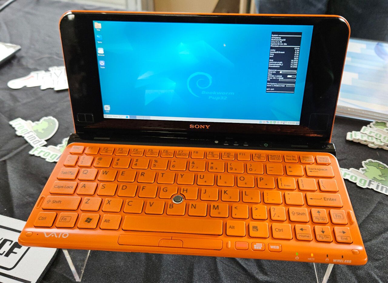 An orange Sony Vaio computer running Linux.